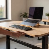 Standing desk with keyboard and laptop
